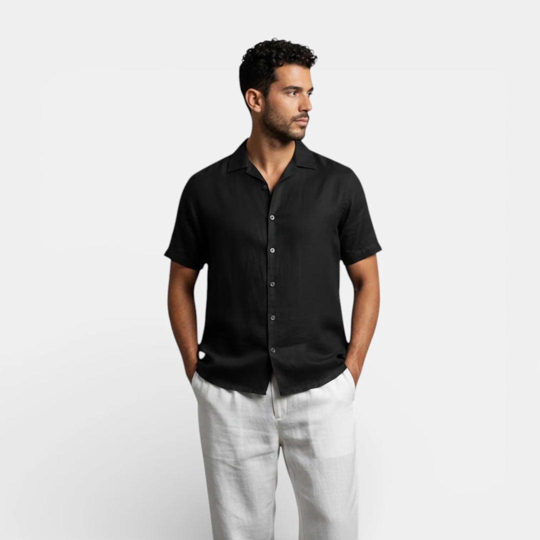 Close-up view of men's black short sleeve shirt showing textured fabric and button placket detail