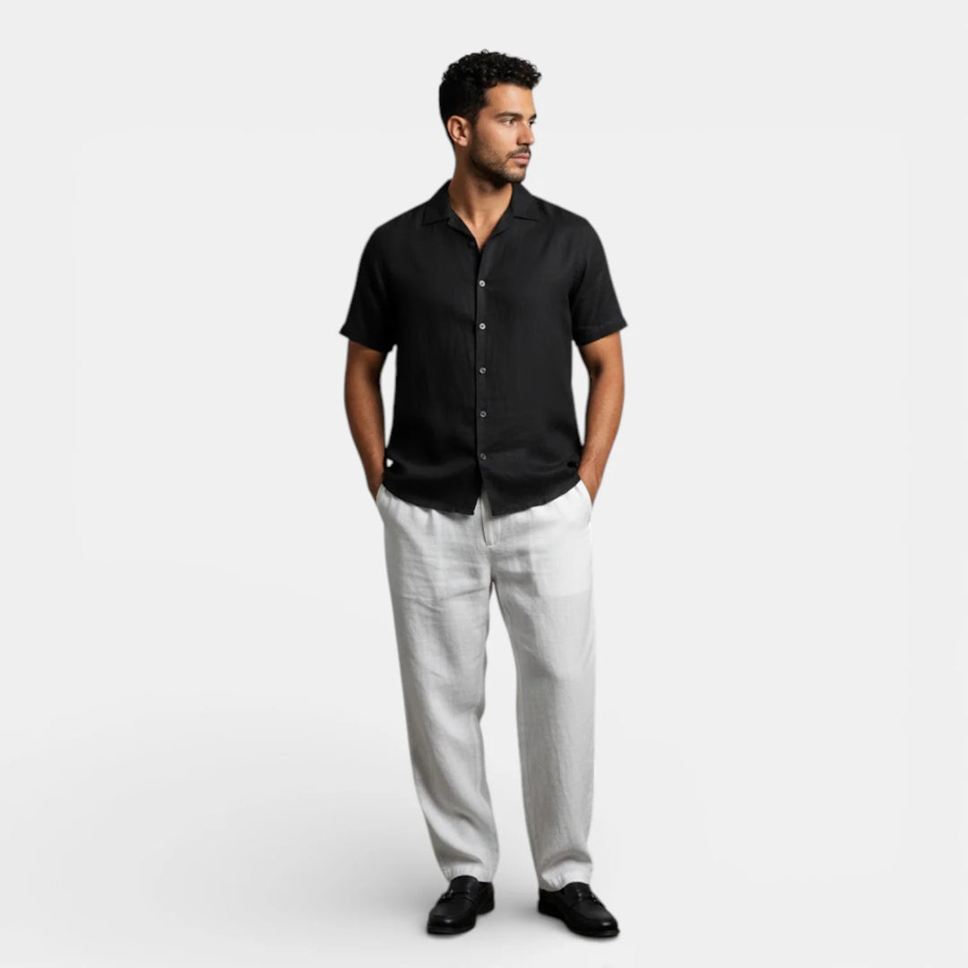 Detail of men's short sleeve shirt collar and shoulder construction in black fabric