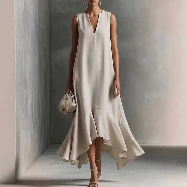 Woman wearing a V Neck Flowy Sundress in soft hemp beige with ruffle hem and deep V-neckline