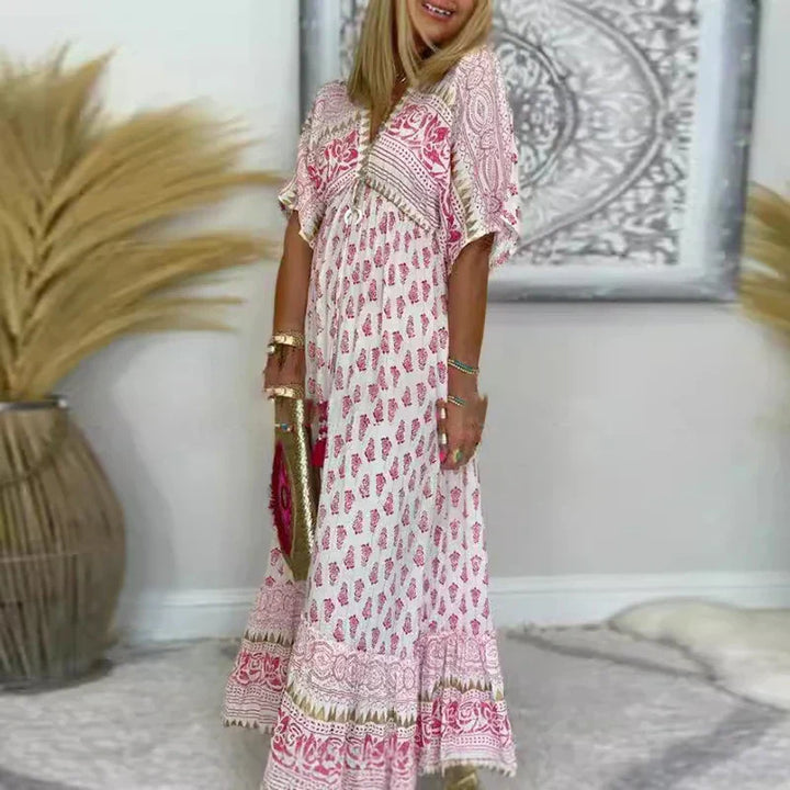 Boho print maxi dress with V-neck, short sleeves, and decorative border detailing in pink tones