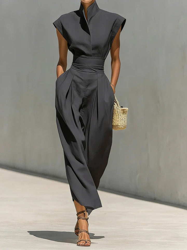 Close-up of structured midi dress stand collar and padded shoulder construction with tailored seams