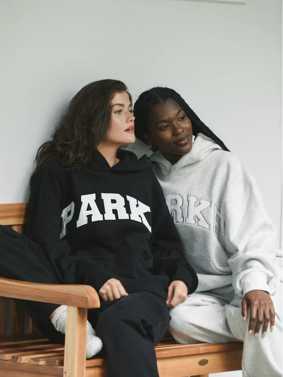 Black varsity sweatshirt with white chenille lettering in oversized fit