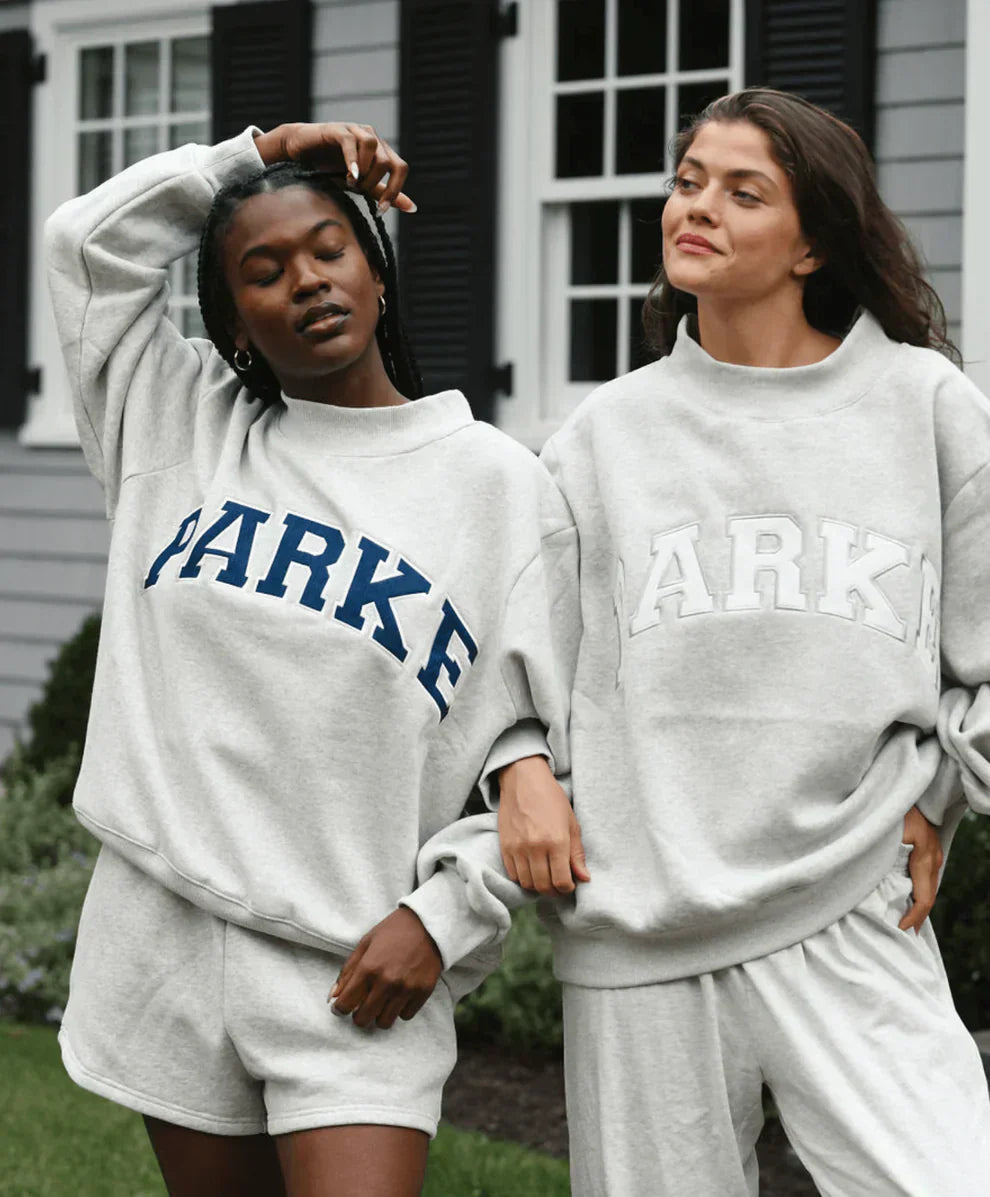 Collection of varsity sweatshirts in multiple colorways with contrasting chenille lettering