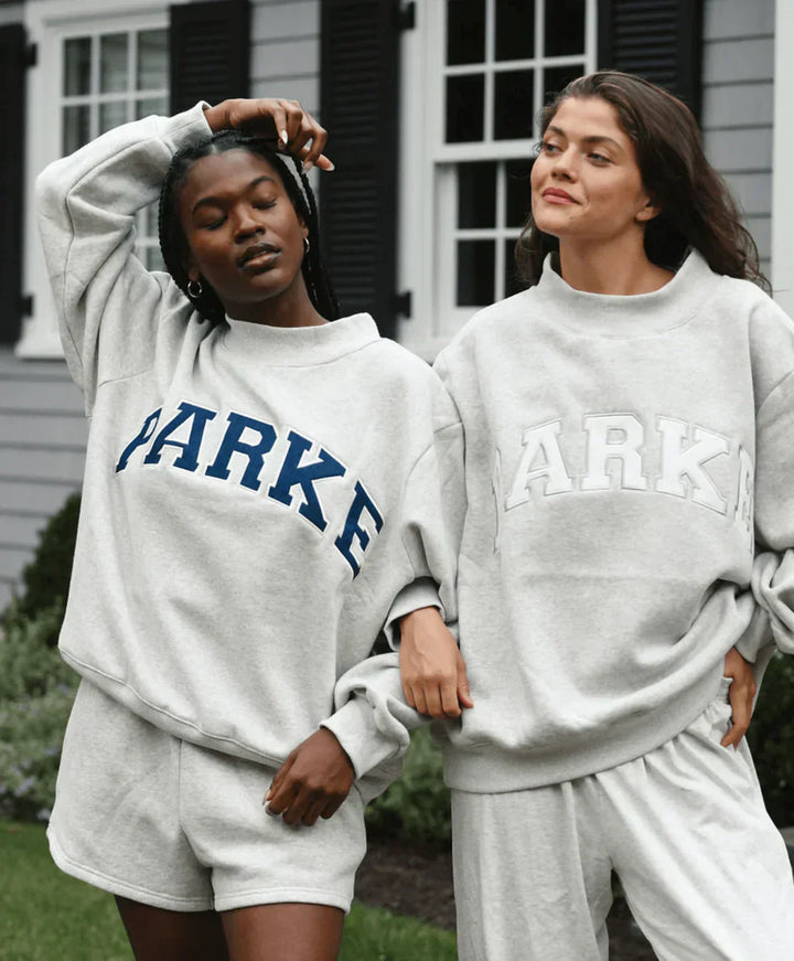 Collection of varsity sweatshirts in multiple colorways with contrasting chenille lettering