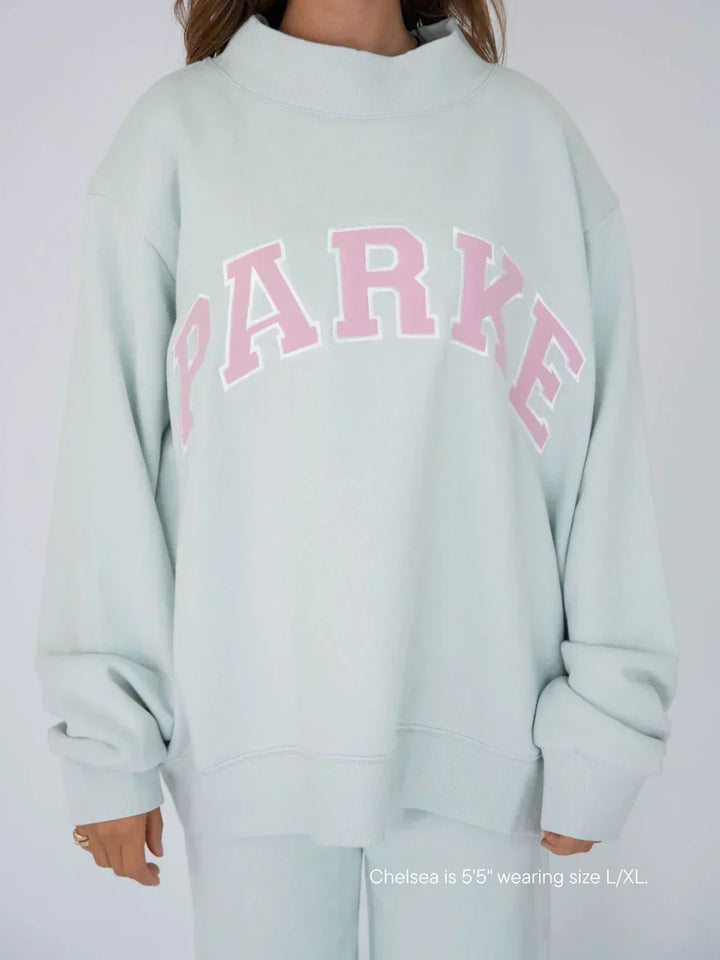 Back view of oversized crewneck varsity sweatshirt showing relaxed silhouette and hem