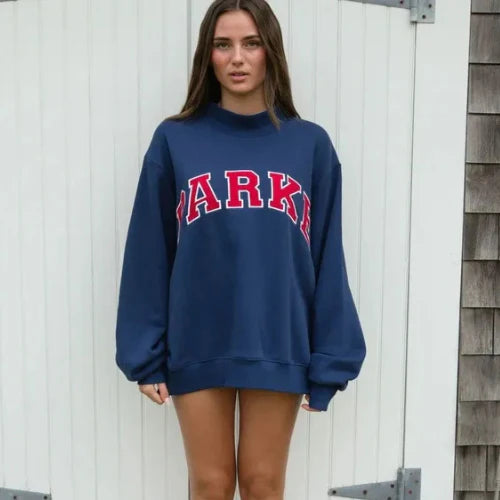 Full-length view of oversized varsity sweatshirt showing roomy fit and length