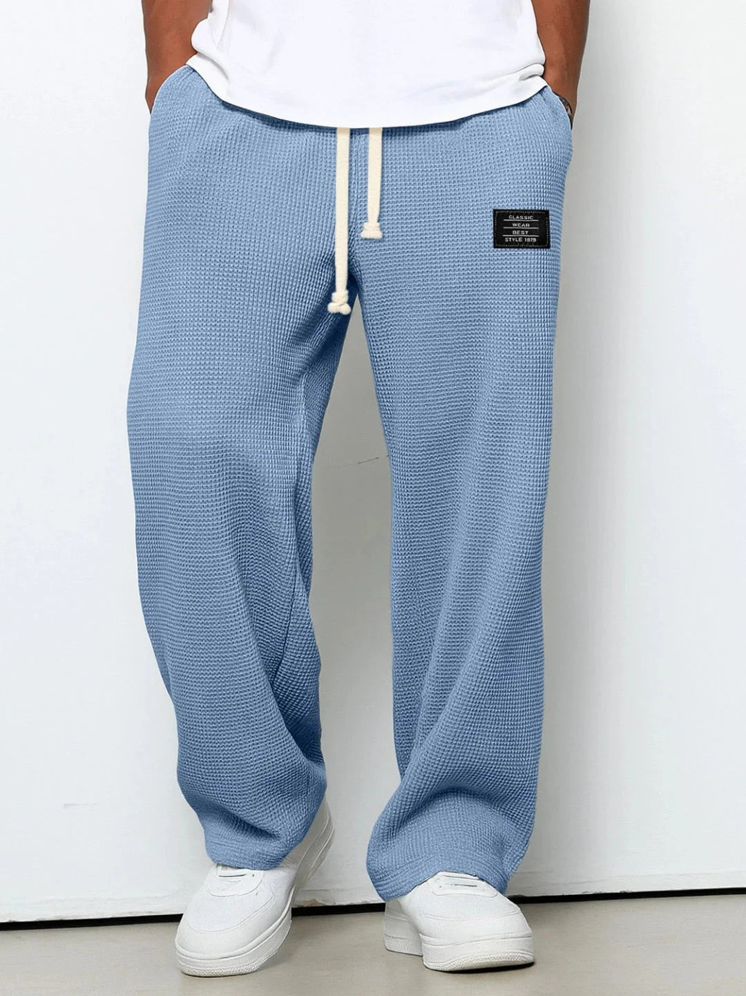 Sky blue waffle textured joggers with adjustable drawstring waist and patch detail at hip