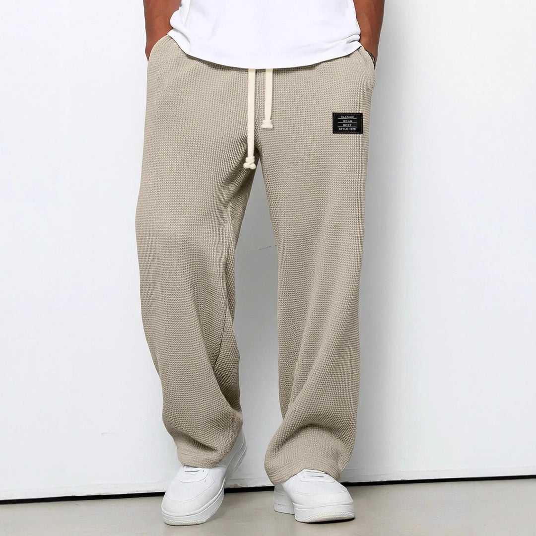 Side view of waffle knit joggers displaying relaxed fit and textured fabric drape