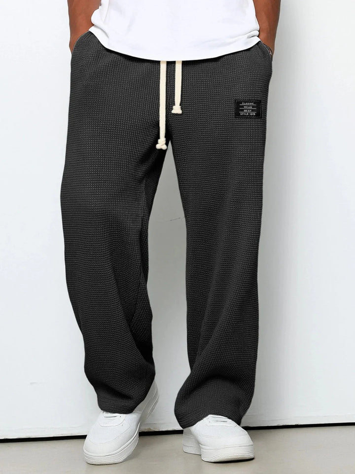Men's straight leg joggers in textured waffle fabric with patch accent detail