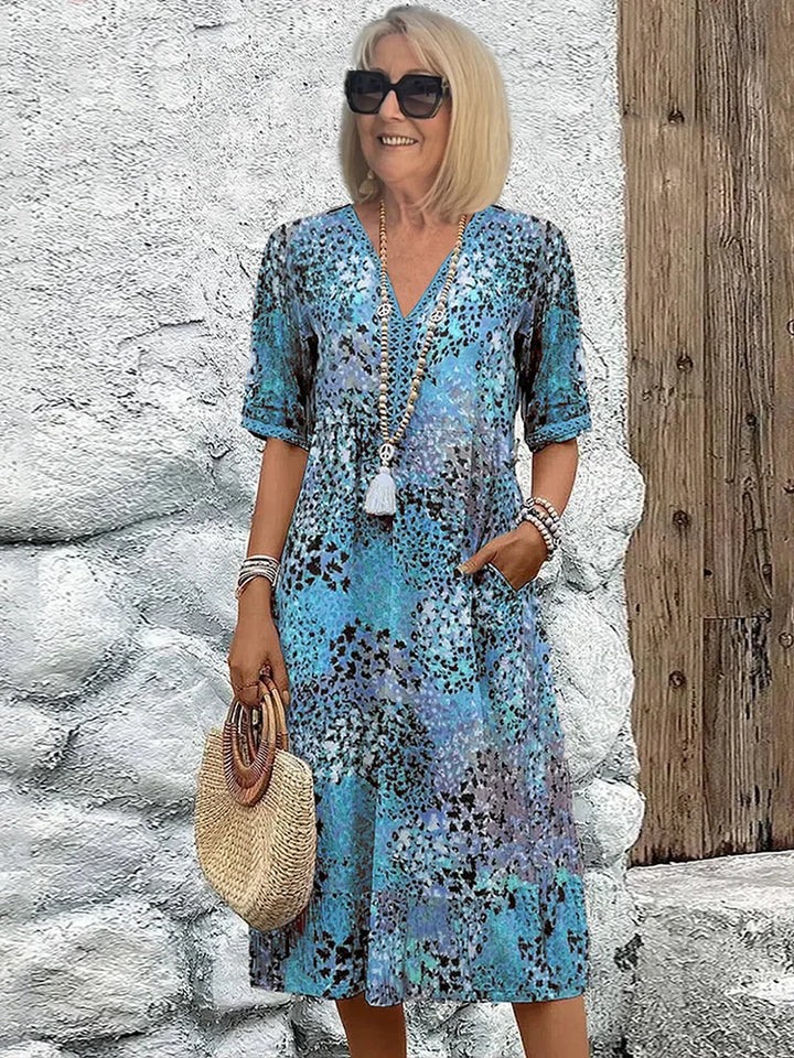 Close-up view of the colorful floral pattern and V-neck detail on this cotton summer dress