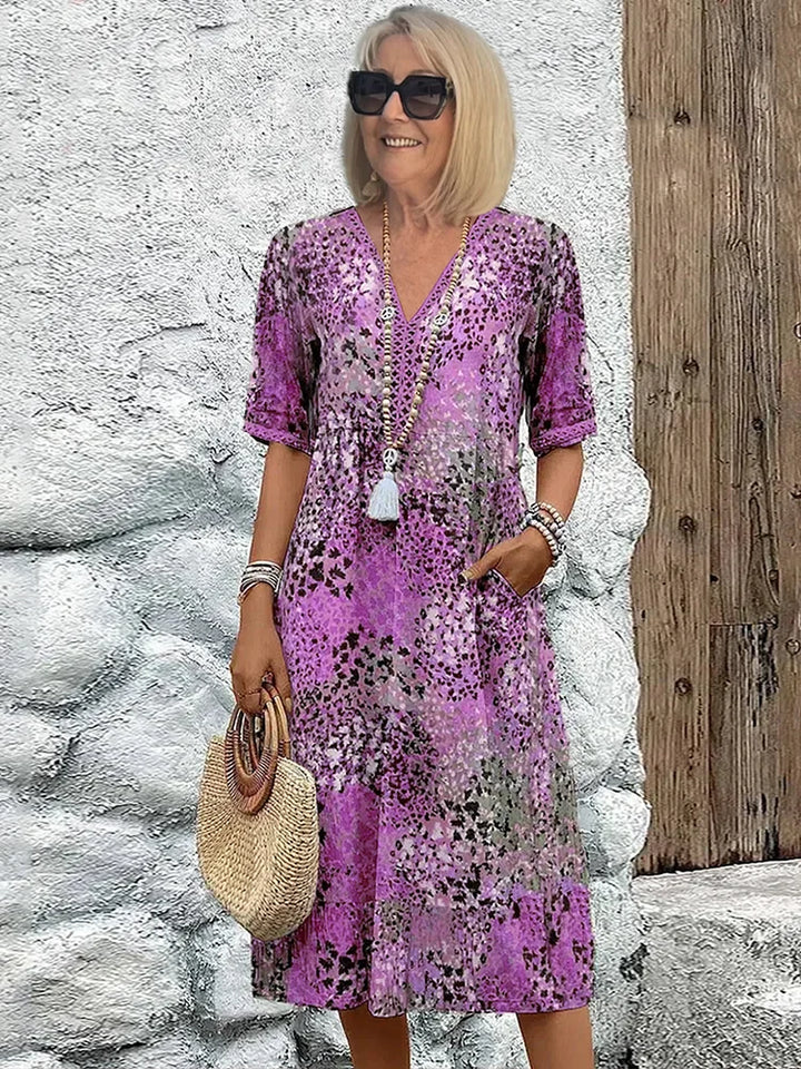 Detail of the elbow-length sleeves and side pockets on this floral cotton summer dress