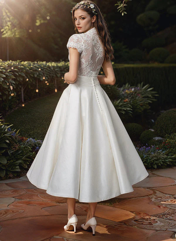 Vintage-inspired lace midi wedding dress with short sleeves and structured skirt for bridal celebrations