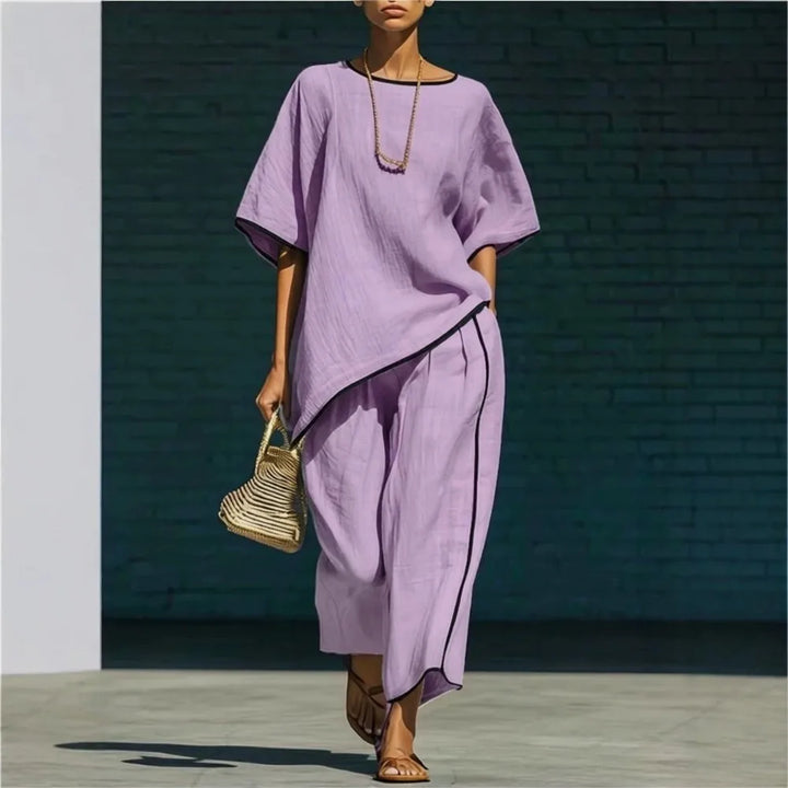 Side view of linen cropped pant set showing relaxed silhouette and navy piping detail