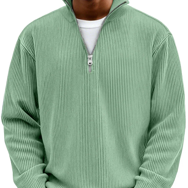 Side angle of relaxed fit zipper sweater with high neck collar and structured ribbed fabric