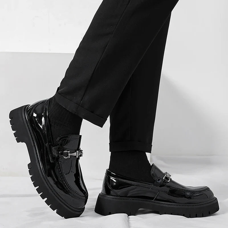 Close-up of black leather dress loafers highlighting smooth upper and stitching detail