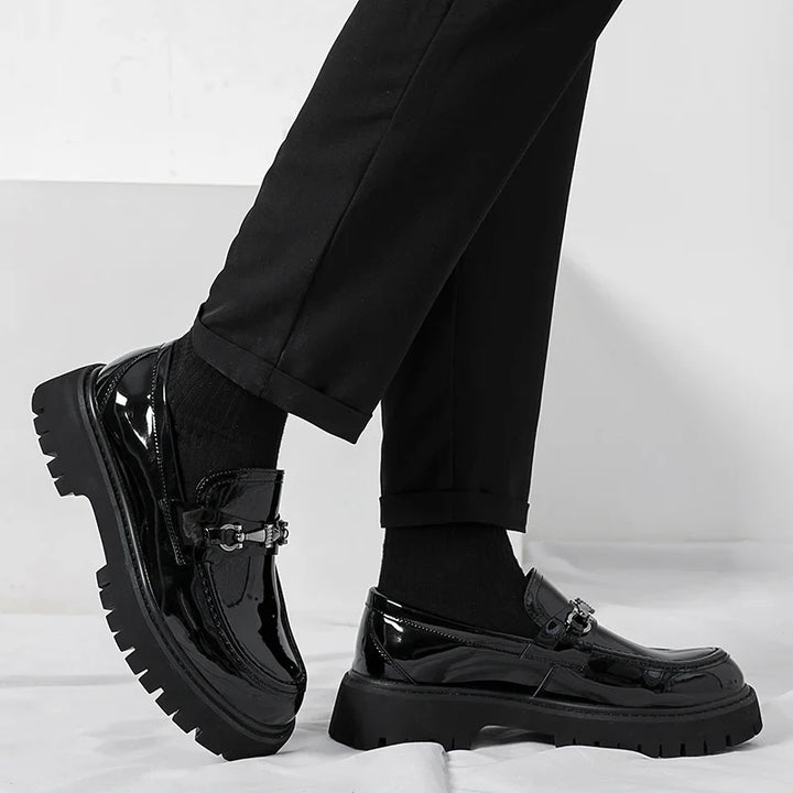 Close-up of black leather dress loafers highlighting smooth upper and stitching detail