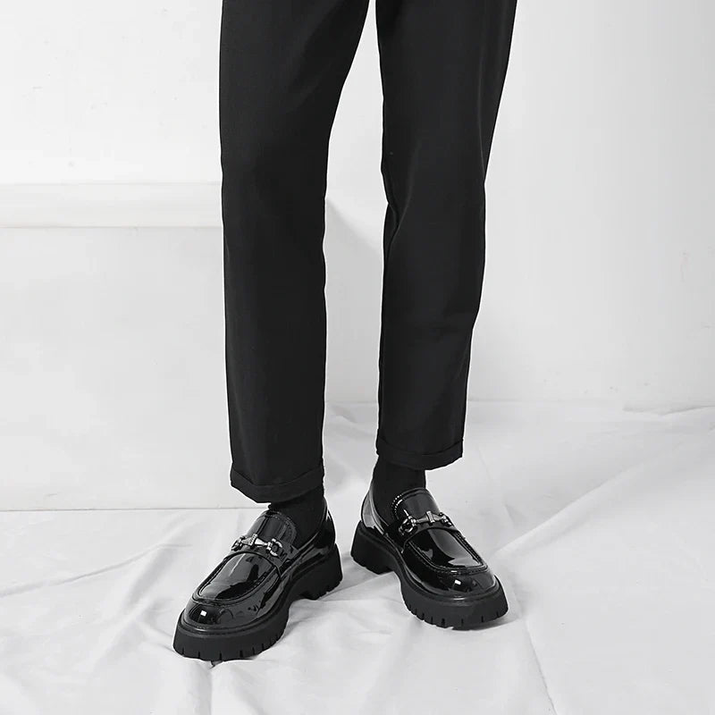 Black leather dress loafers for women showing chunky lug sole and structured silhouette