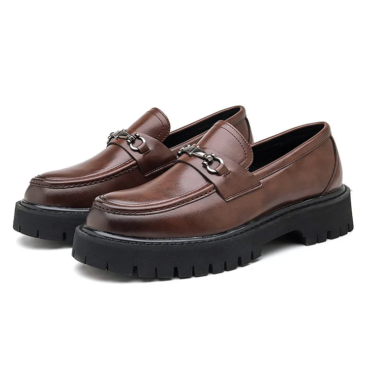 Pair of women's leather dress loafers in brown with metal buckle accent detail