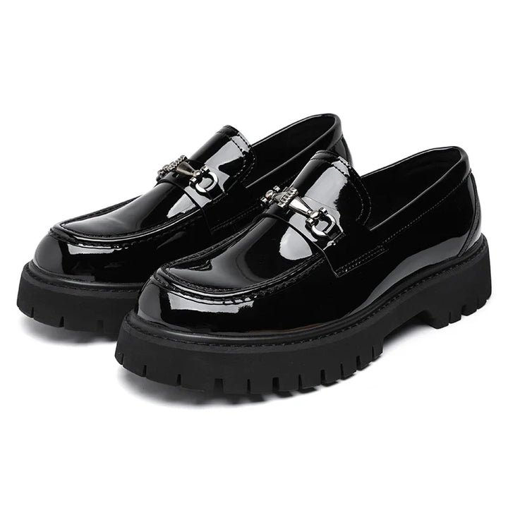 Women's leather dress loafers in black on neutral background showing polished construction