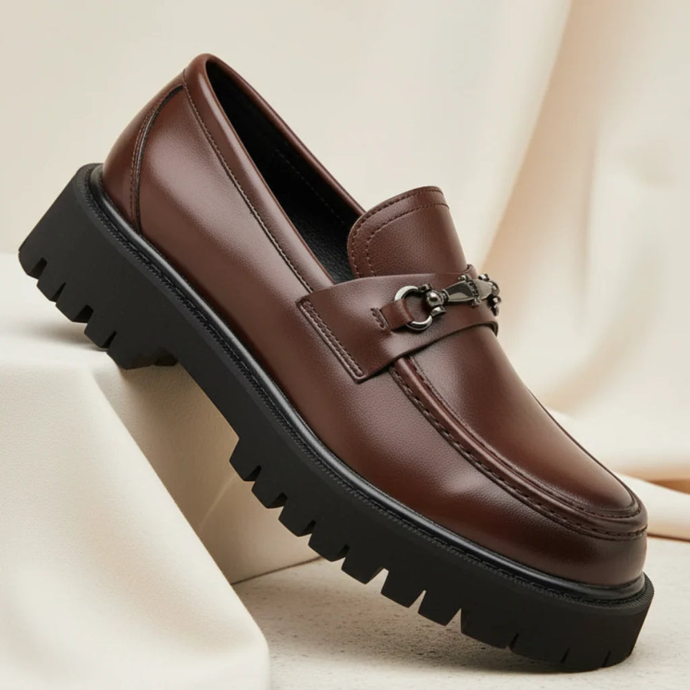 Side view of brown leather dress loafers showing structured upper and visible stitching