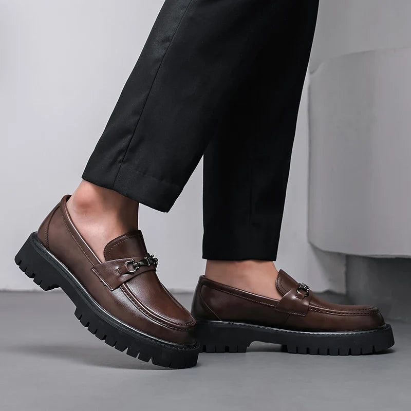 Close-up of metal buckle accent on women's leather dress loafers