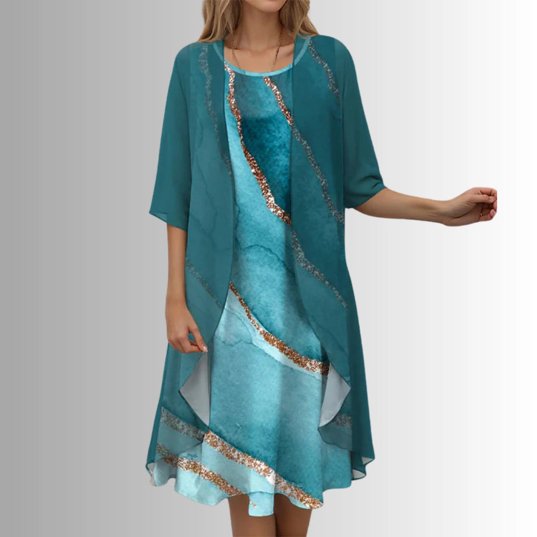 Detail of floral print inner dress with sage green outer layer and 3/4 sleeves