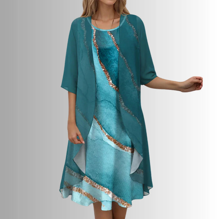 Detail of floral print inner dress with sage green outer layer and 3/4 sleeves
