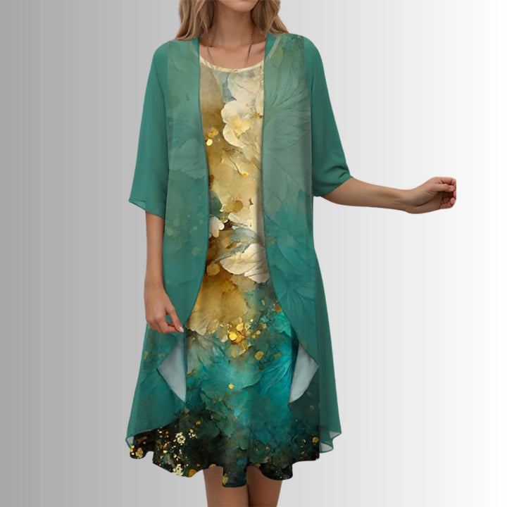 Back view of layered midi dress showing draped overlay and mid-calf length