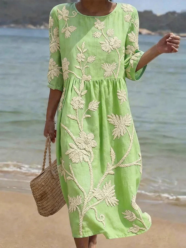 Back view of the Elegant Embroidered Midi Dress with round neckline and embroidered floral pattern