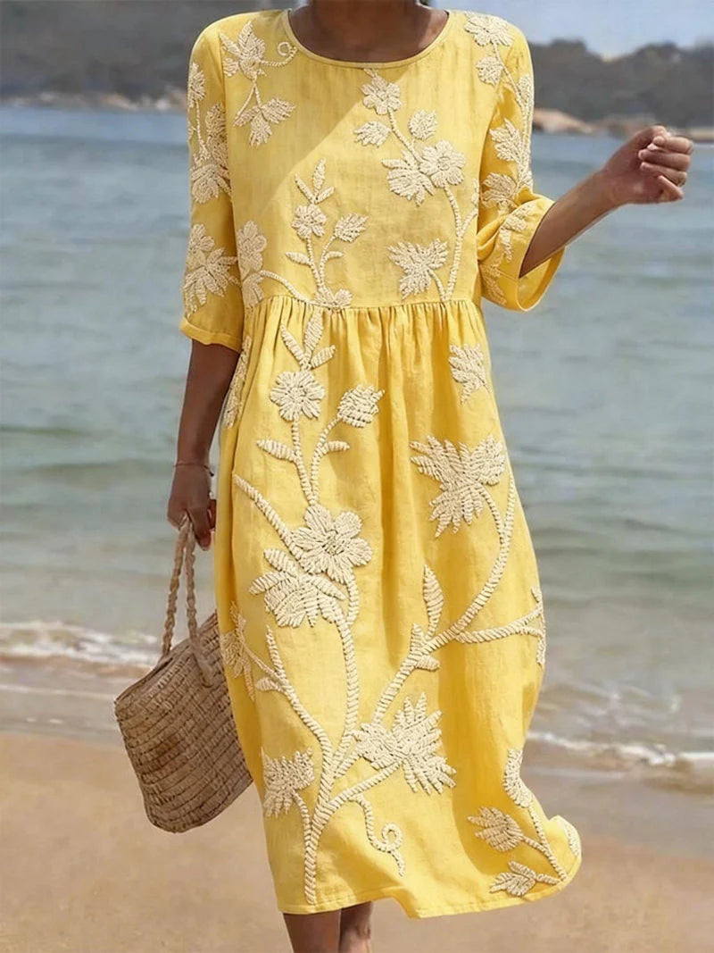 Full-length view of the Elegant Embroidered Midi Dress styled with woven accessories for a summer look