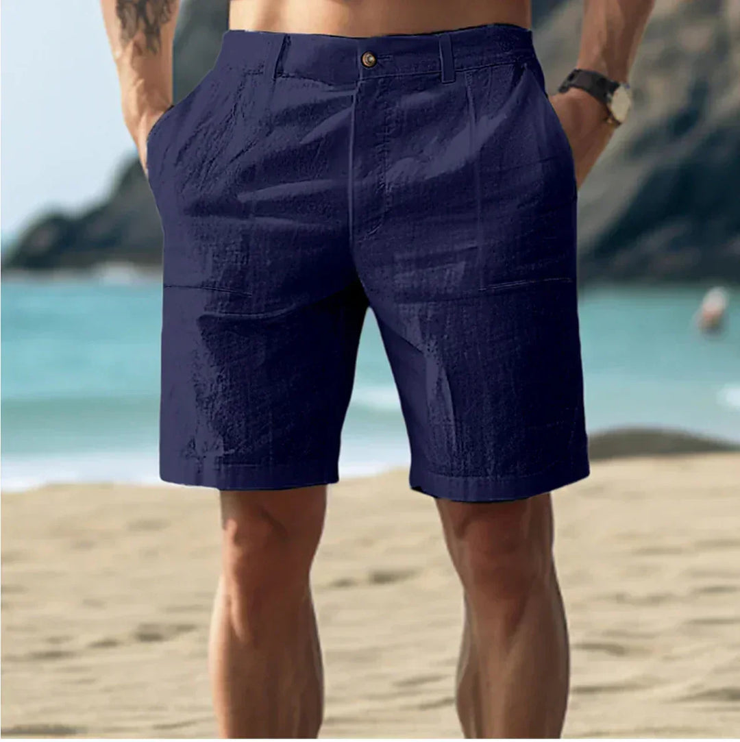 Close-up of men's summer shorts button closure and lightweight woven fabric texture detail