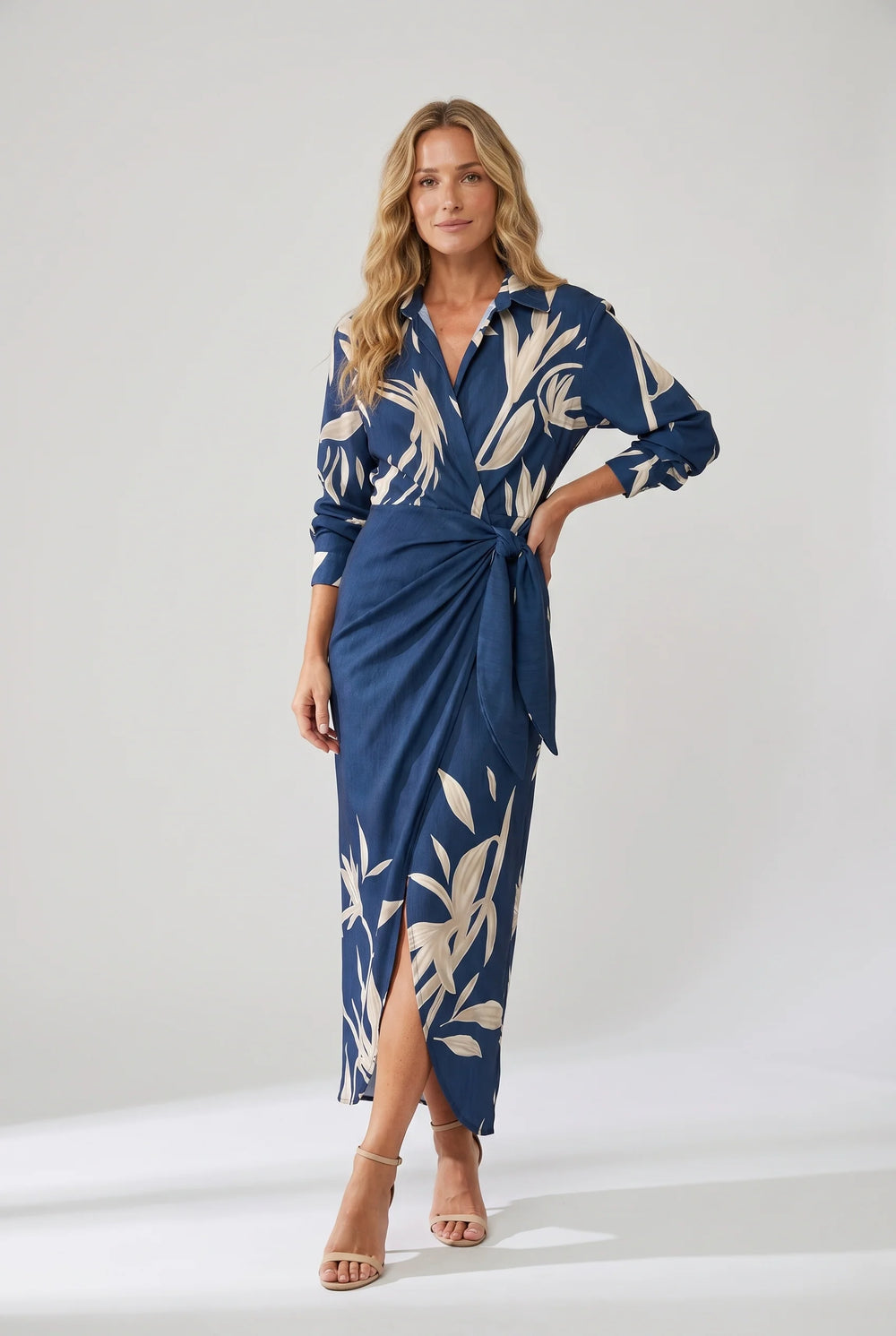 Side view of wrap maxi dress showing draped skirt and side slit detail with leaf motif