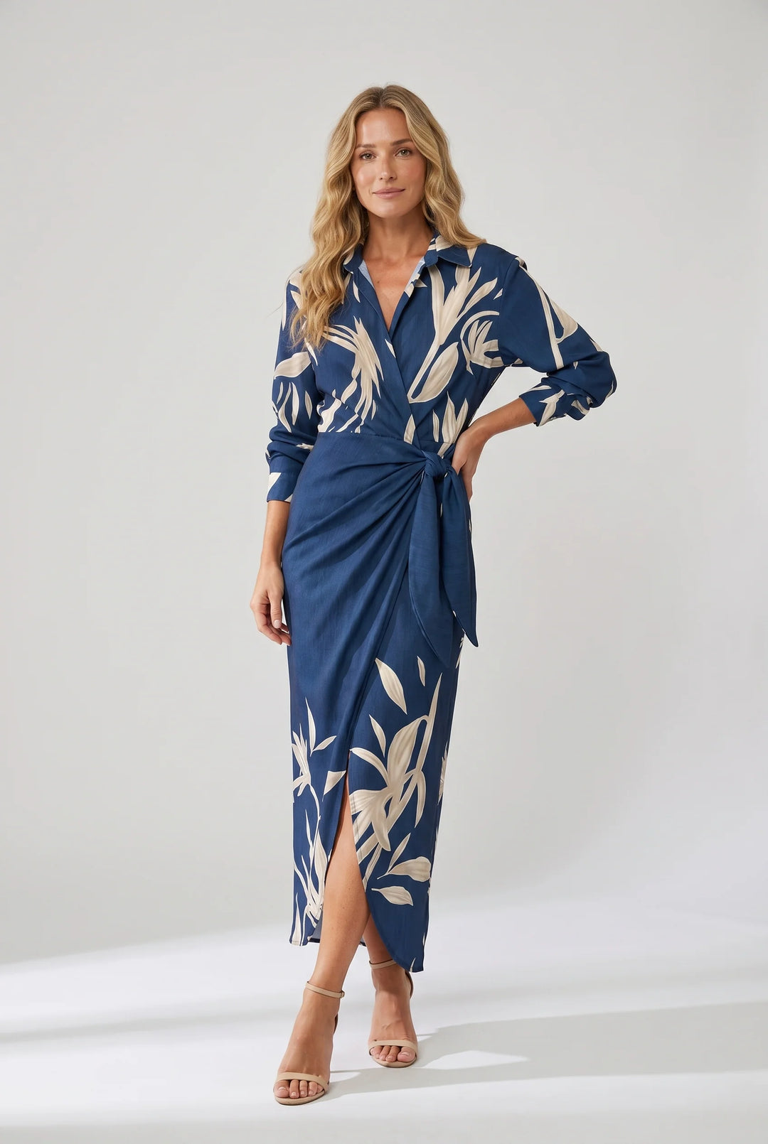 Side view of wrap maxi dress showing draped skirt and side slit detail with leaf motif