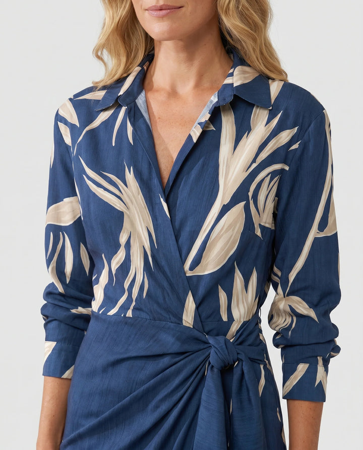 Detail of twist-tie waist and wrap-front closure on navy leaf print dress
