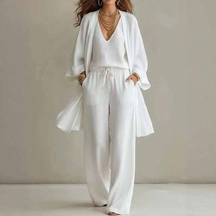 Woman wearing white Linen 3 Piece Co-ord Set with long sleeve cardigan, V-neck top, and wide leg pants
