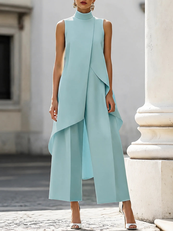 Navy blue women's two-piece set featuring sleeveless turtleneck and architectural drape