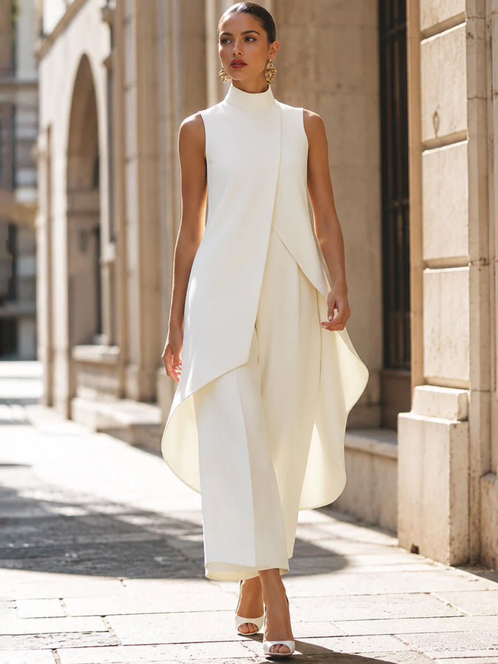 Side angle of sleeveless turtleneck two-piece set highlighting structured silhouette and fluid drape