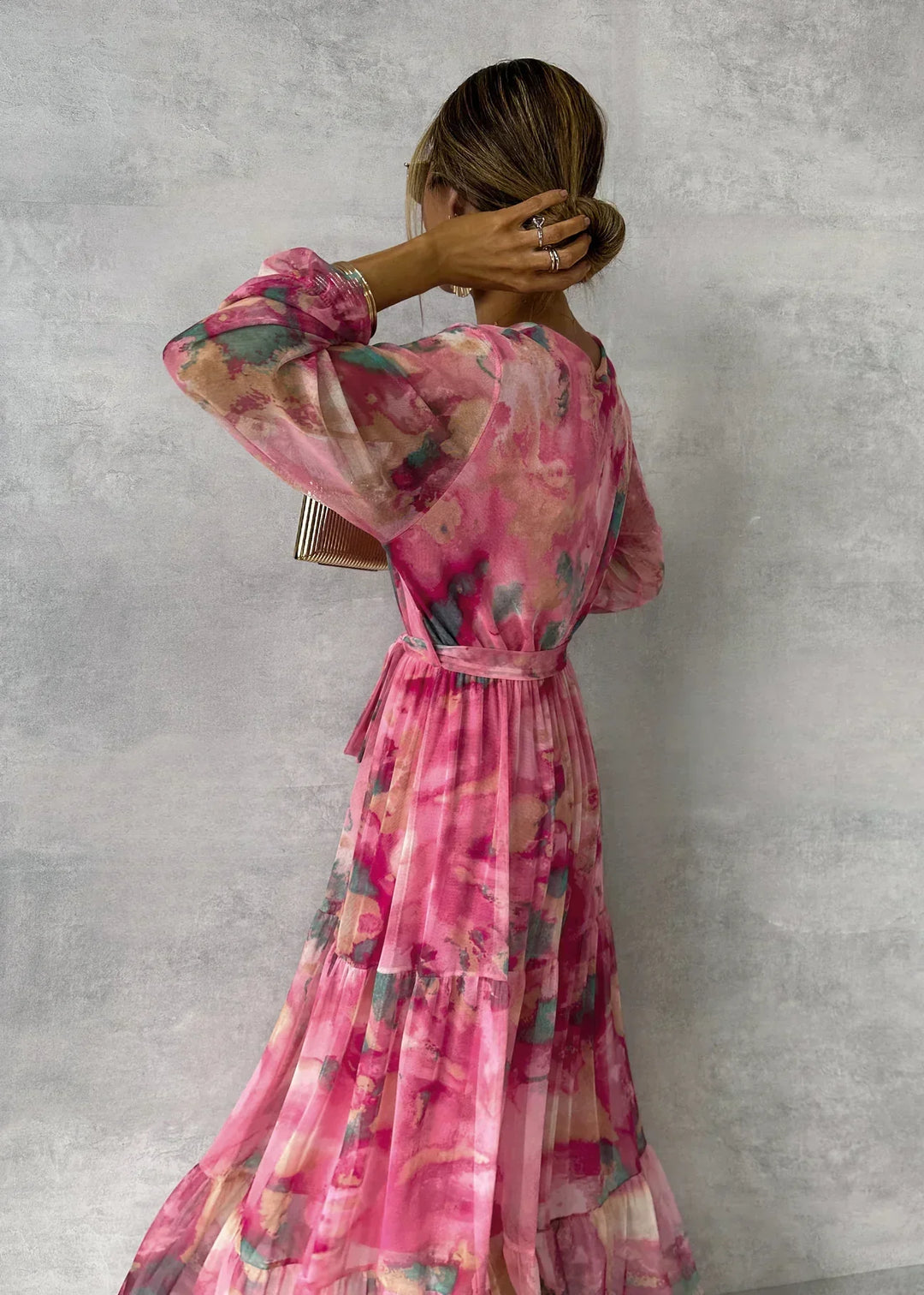 Side view of floral wrap maxi dress showing tie waist detail and flowing tiered skirt
