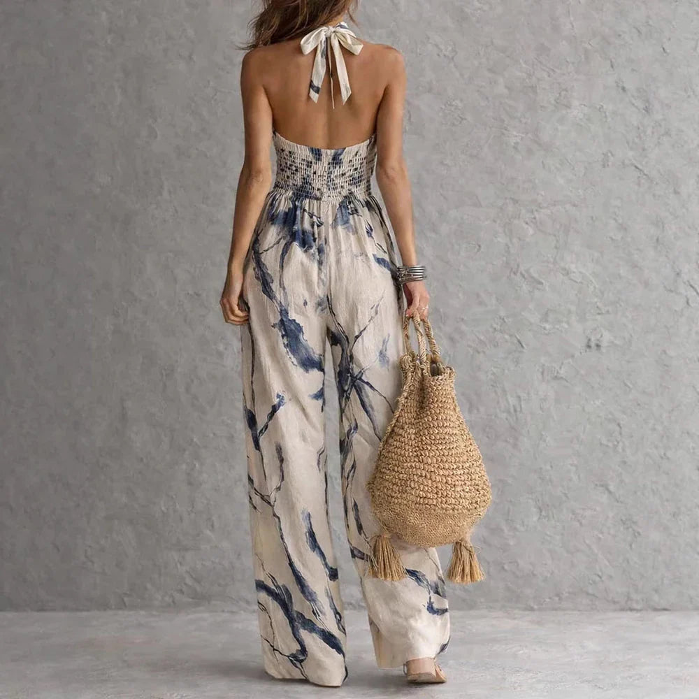 Full-length view of flowy halter maxi dress showing floor-length hem and high waist silhouette