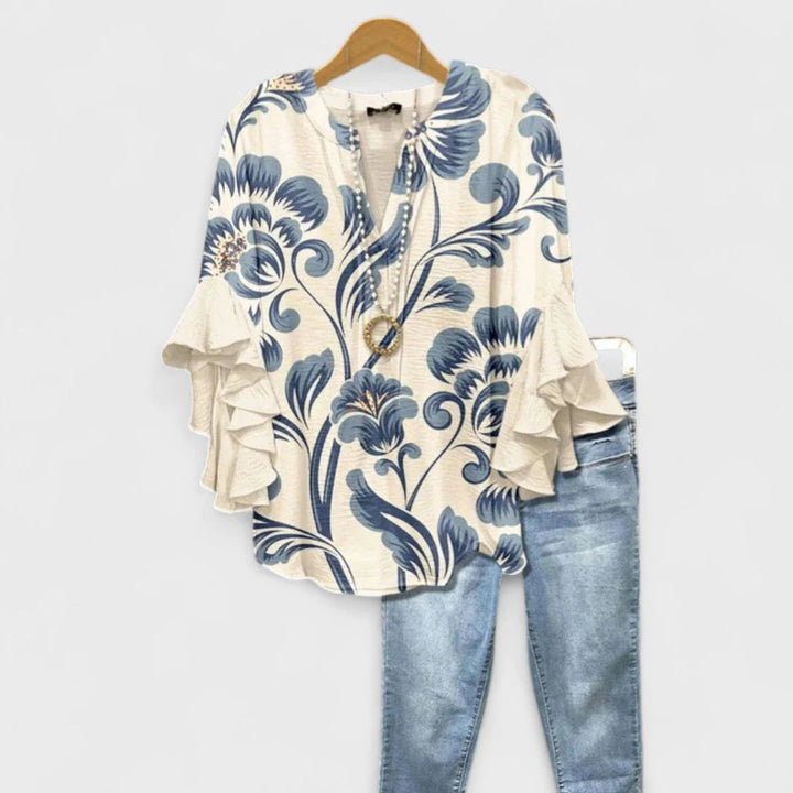 Women's floral print ruffle sleeve blouse with v-neck opening and layered sleeve detail on hanger