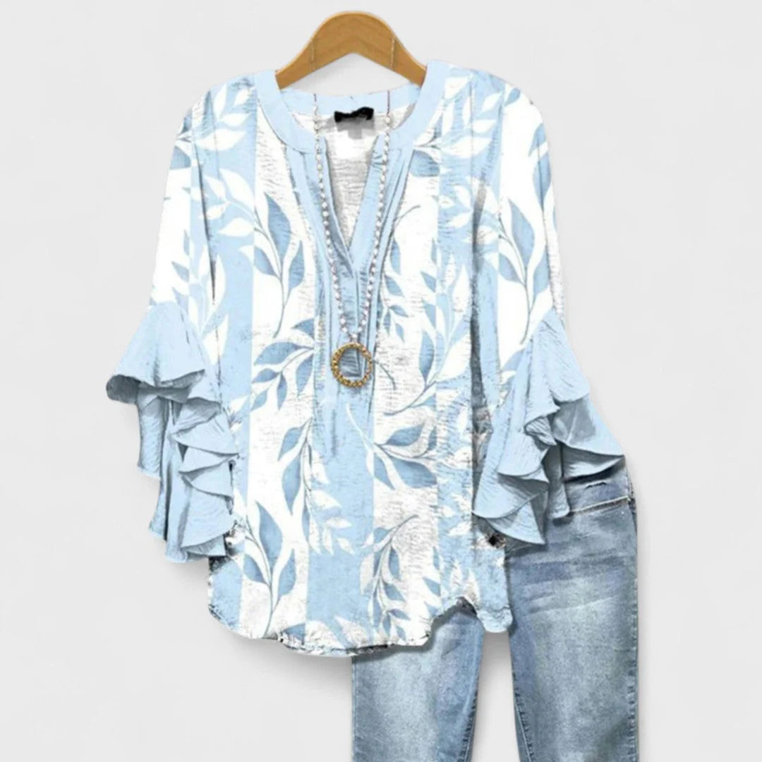 Close-up view of floral print ruffle sleeve blouse showing blue botanical pattern and sleeve construction