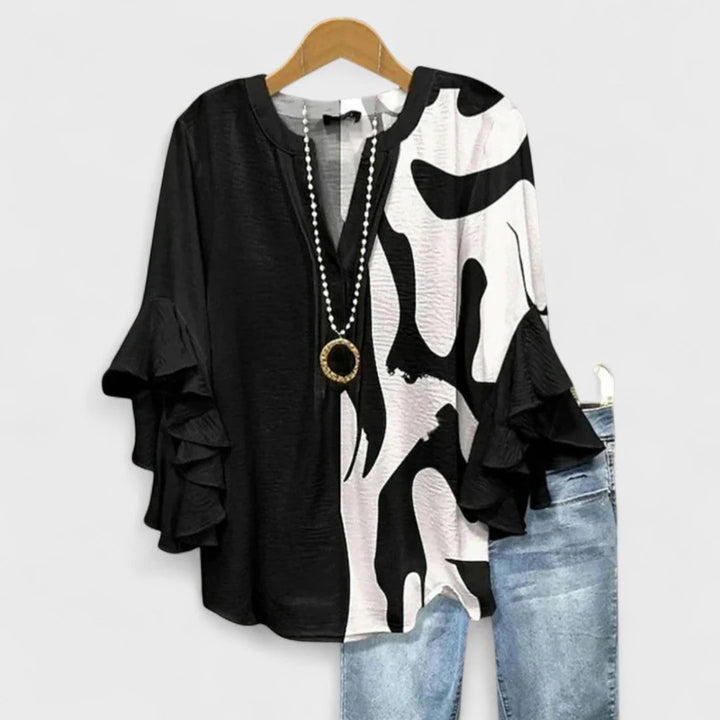 Women's relaxed fit floral blouse with elbow-length ruffle sleeves and rounded hemline
