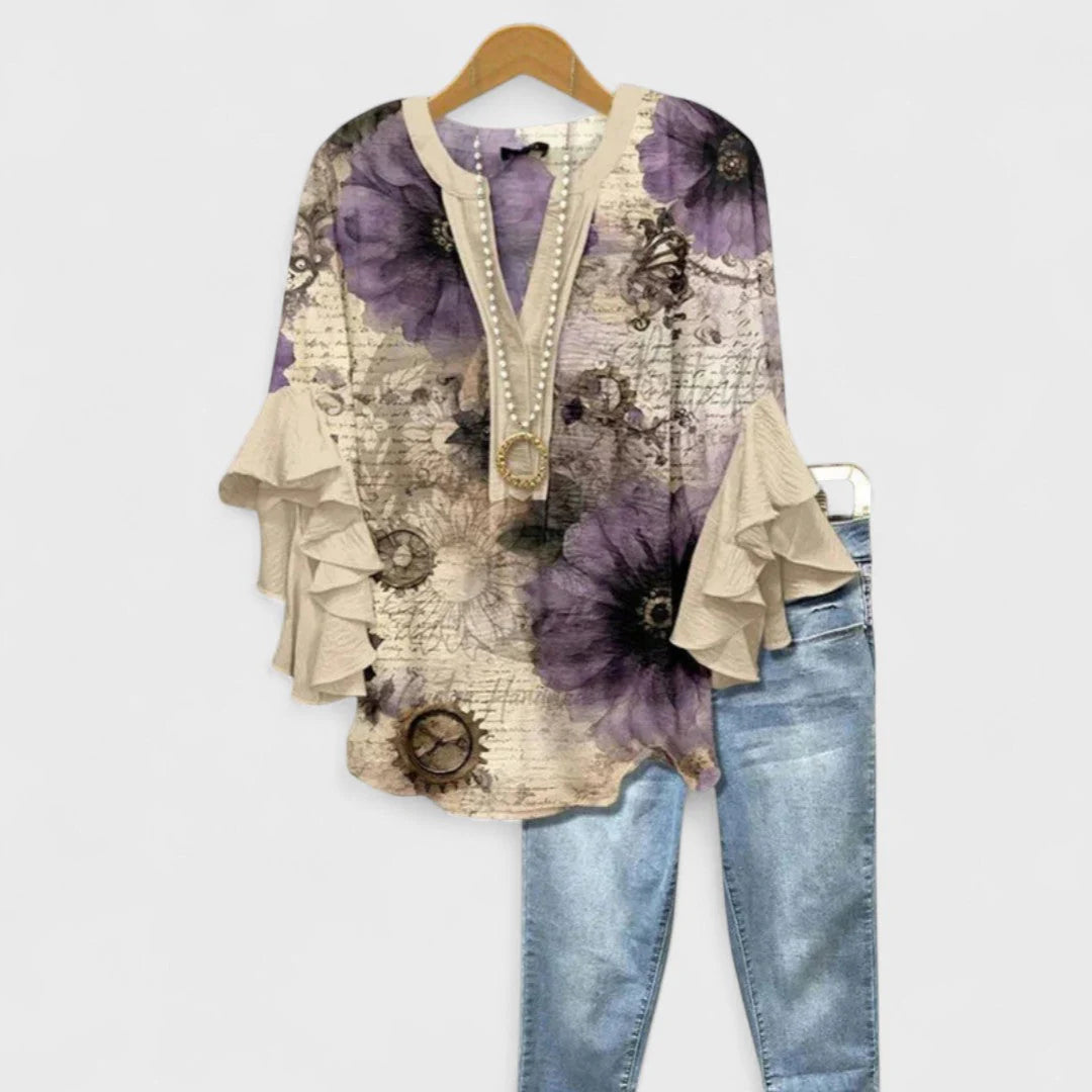 Side view of floral print v-neck blouse showing sleeve ruffle layers and body silhouette
