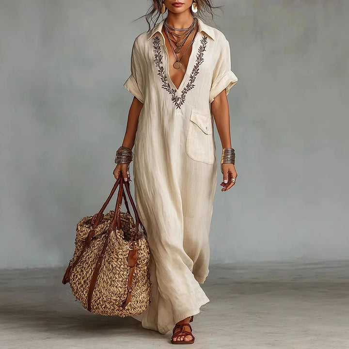 Riley V neck kaftan dress in beige with embroidered neckline and full-length flowing silhouette for vacation wear