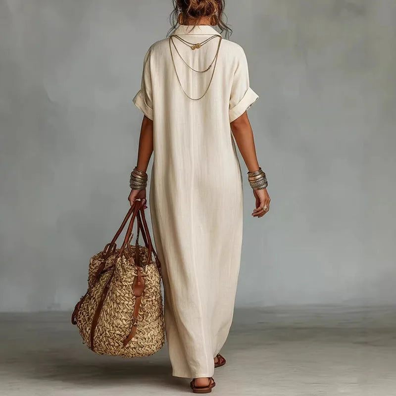 Front view of V neck kaftan dress showing embroidered detail and relaxed short sleeve design