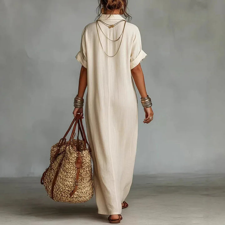 Front view of V neck kaftan dress showing embroidered detail and relaxed short sleeve design