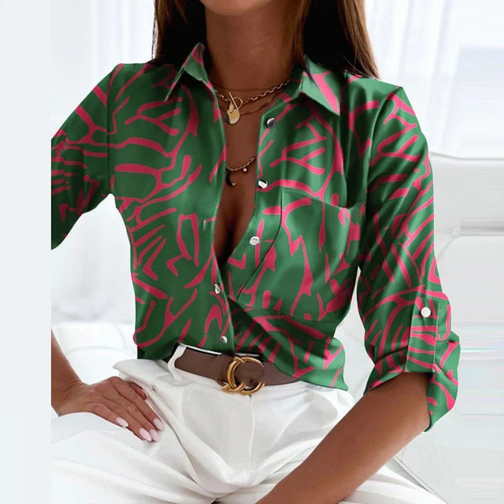 Classic collared blouse with roll-tab sleeves and button-front placket in geometric print