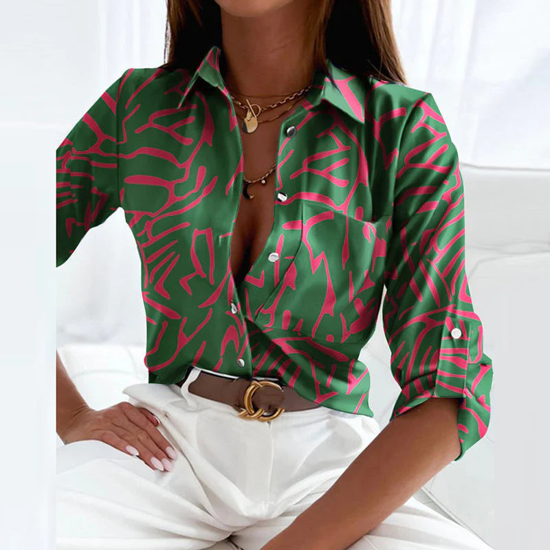 Women's classic collared blouse in geometric print paired with white pants and belt