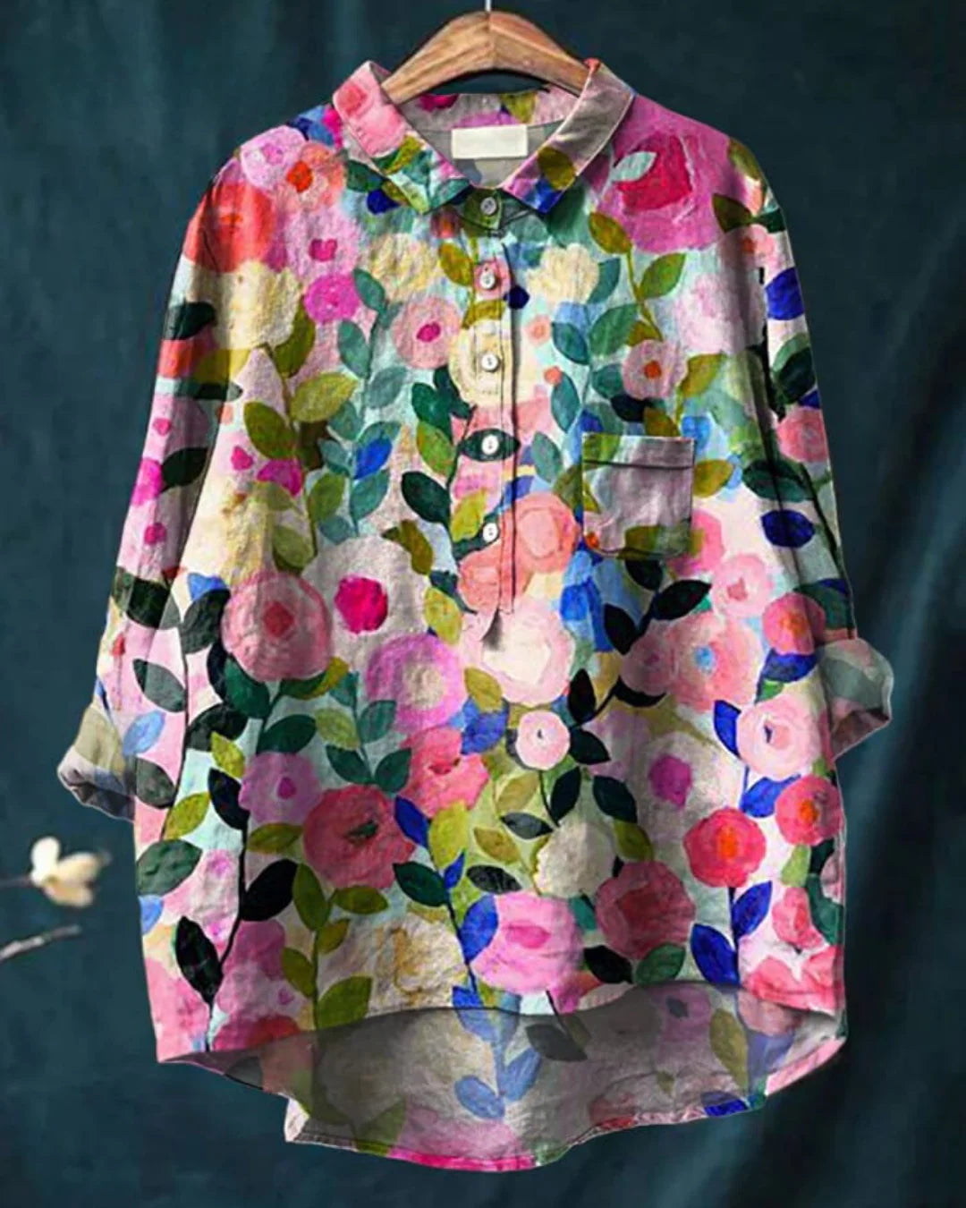 Women's floral print button-front shirt with abstract multicolor pattern and collared neckline on hanger