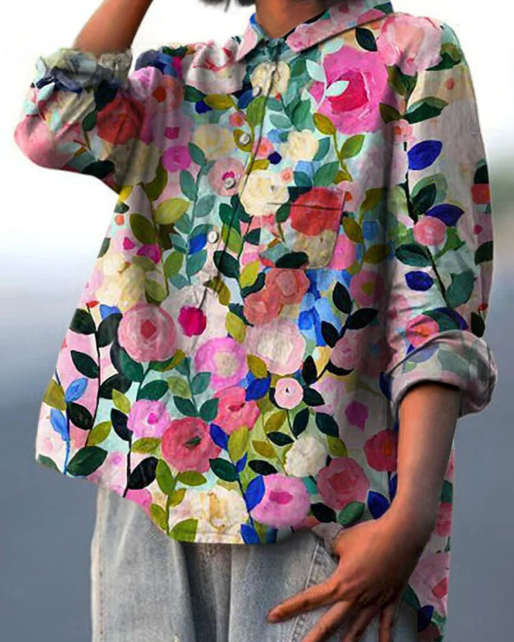 Close-up of women's floral print shirt showing button closure and chest pocket detail